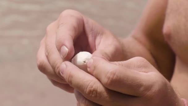 Man passes fishing line and stick through handmade bobber, hands closeup. — Stock Video