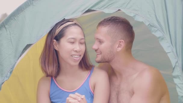 Couple of lovers in tent. Man is kissing his girlfriend. Camping in nature. — Stock Video