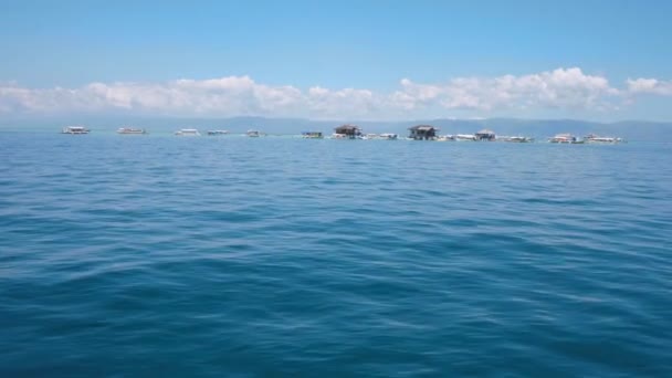 Scenery seascape from boat on island with ships and houses in a tropical island. — Stock Video