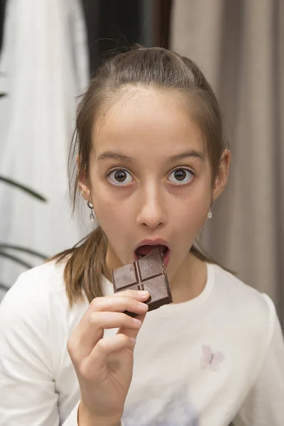 Surprised Girl Eating Delicious Brown Chocolate — Stock Photo, Image