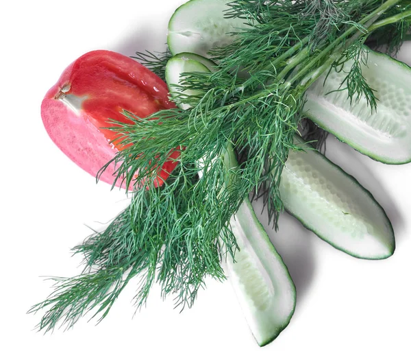 Slices of cucumber and tomato with a bunch of dill isolated on white background.