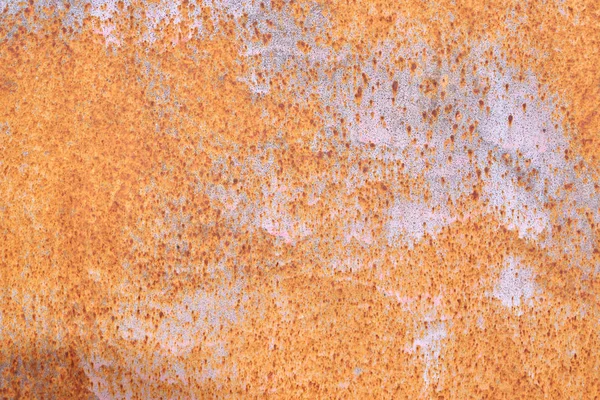 Rusted painted metal wall. Rusty metal background with streaks of rust. Rust stains. The metal surface rusted spots.