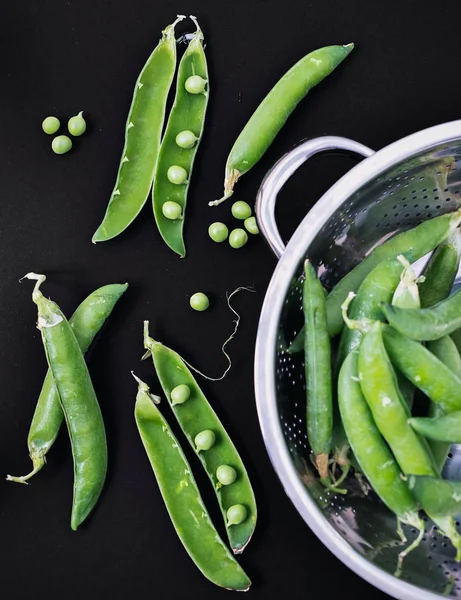 Fresh pea pods and green peas