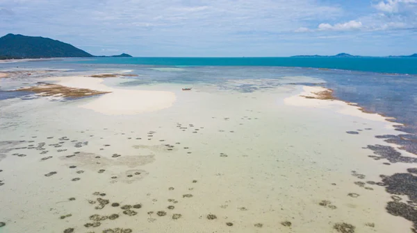 aerial photography of the Indian Ocean coastline. Burmese gather oysters in shallow waters.