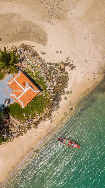 aerial drone photography of the ocean coast with gazebo and fishing boats