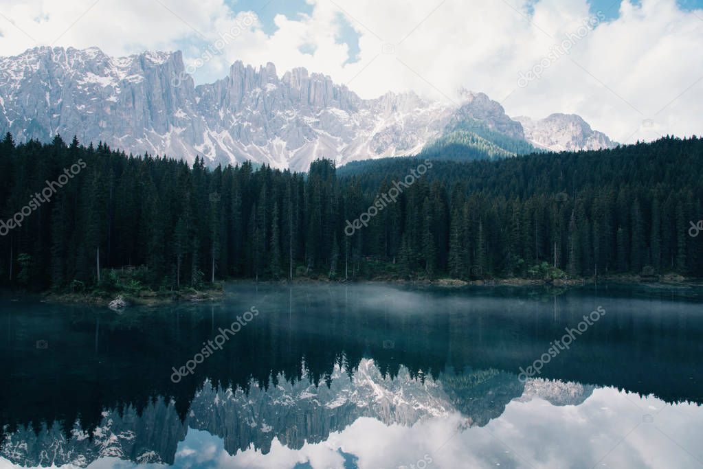 The Karersee lake with reflection of mountains in the Dolomites.