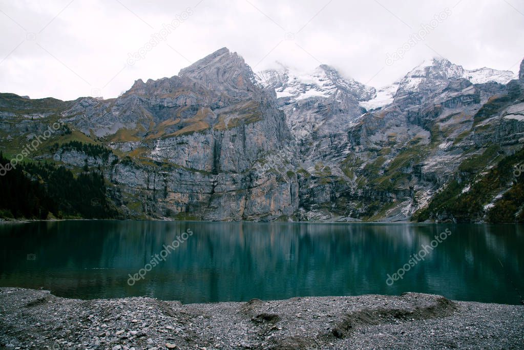 View of Oeschinen Lake in the Swiss alps with beautiful turquoise water. Nature and travel concepts.