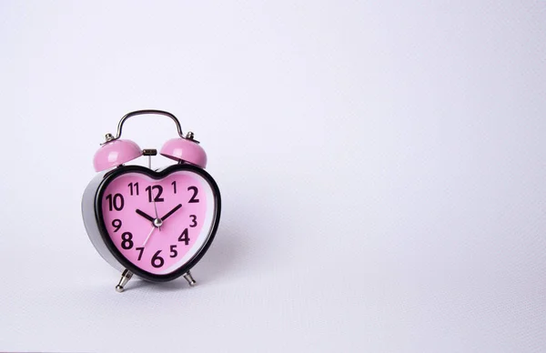 Heart shaped clock on pink background. — Stock Photo, Image