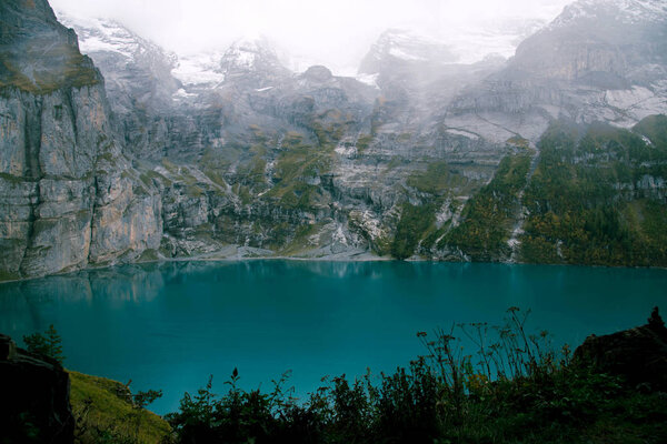 View of Oeschinen Lake in the Swiss alps with beautiful turquoise water.