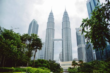 Kuala Lumpur. Petronas Twin towers and neighboring skyscrapers in golden-blue light. clipart