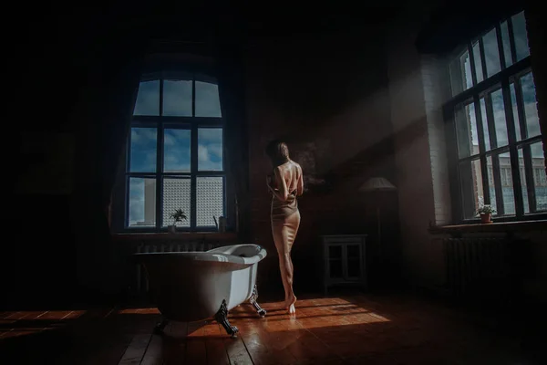 Banyo ile eski dekore edilmiş odada ayakta elbiseli kadınlar