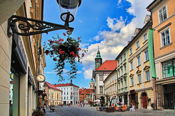 LJUBLJANA, SLOVENIA - JUNE 28, 2014: Street in the old city center of Ljubljana with street shops and cafes. LJUBLJANA, JUNE 28, 2014.