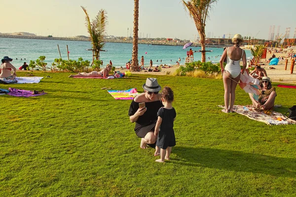 La Mer in Dubai, UAE - May 06, 2018: Mom with baby on the beach — Stock Photo, Image