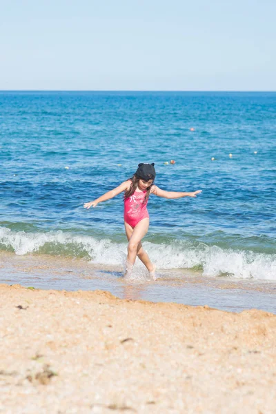 Una Niña Traje Baño Rojo Una Gorra Negra Bailando Playa —  Fotos de Stock