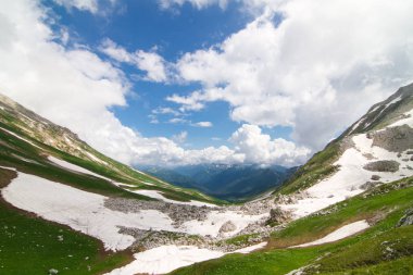 Dağı geçmek arka plan yüksek Dağları kar ile kaplı yeşil tepelerin arasında