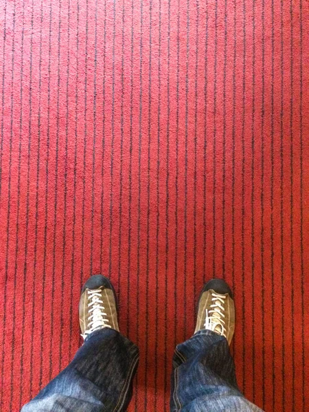 Standing on a red fabric floor. — Stock Photo, Image