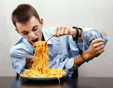 an young man eating spaghetti handcuffed clipart