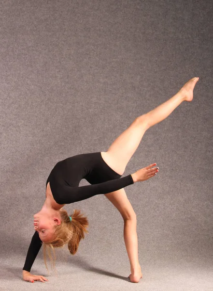 Śliczną Dziewczynkę Czarne Rajstopy Siłowni Robi Gimnastyka Podnosząc Jej Nogi — Zdjęcie stockowe