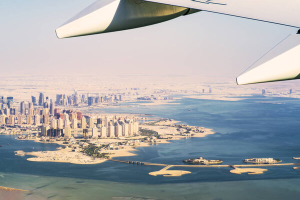 Aerial view of city Doha, capital of Qatar. Airplanes from Qatar Airways .