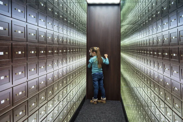 Mirror room illusions.A little girl stands in the room of illusions. The safe room is a multi-colored room of illusions. A room of illusions. Mirror room illusions.