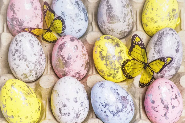 Multi-colored Easter eggs in the egg cells. Happy Easter. Easter card. Close-up.Soft focus.