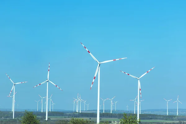 Wind turbine .Sustainable development, renewable energy.Windmills for electric power production,white wind turbine generating electricity on blue sky. — Stock Photo, Image