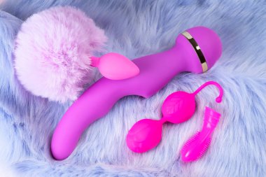 Collection of different types pink and violet of sex toys on violet background.Sex toy for adult, dildo vibrator,pink vaginal balls,clitoral stimulator.