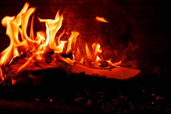 Concept for the destruction of confidential documents.Burning book on fire at night. People don\'t like reading. Intellectual problems.Burning books.