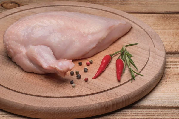 Fresh chicken meat. Fresh chicken fillet with a wing on a wooden cutting board.Raw chicken meat on wooden board. Healthy eating.Chiken supreme.