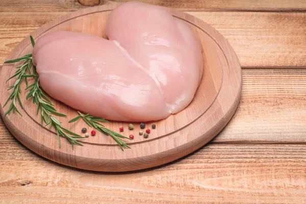 Chicken fillet butterfly on a wooden cutting board.Raw, fresh chicken fillet. Chicken fillet cut in the form of a butterfly.