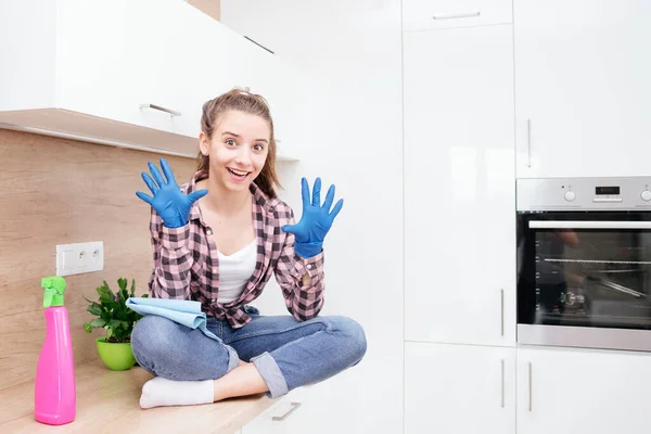 Young woman doing housework, cleaning the kitchen.Young girl cleaning the kitchen. Cleaning the room.