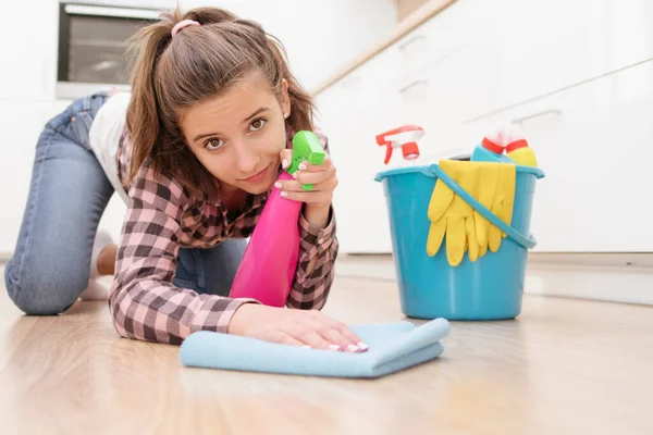 Young woman doing housework, cleaning the kitchen.Young girl cleaning the kitchen. Cleaning the room.