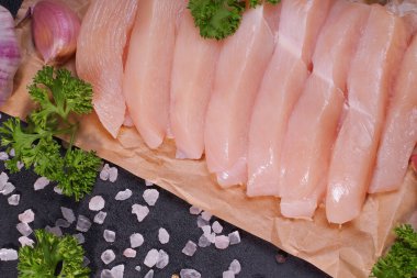 Tavuk parçaları. Arka planda çiğ organik tavuk göğsü. Siyah arka planda çiğ tavuk bifteği..