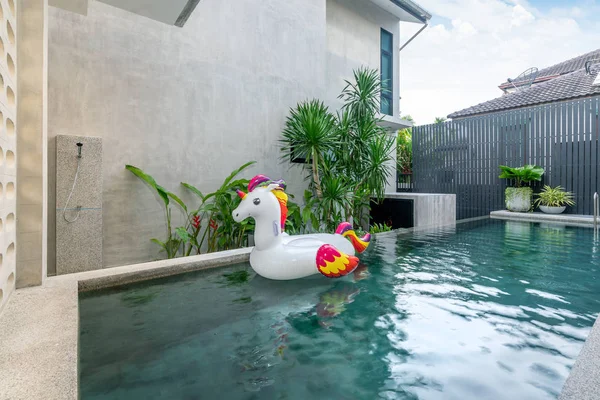 Casa exterior con piscina y unicornio flotante en la casa — Foto de Stock