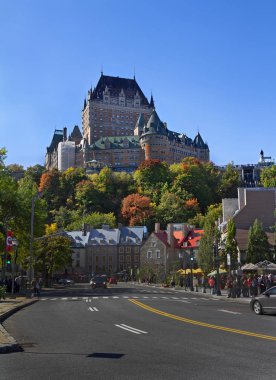 Street with autumn trees and Fairmont Le Chteau Frontenac Hotel in Old Town, Quebec City, Canada clipart