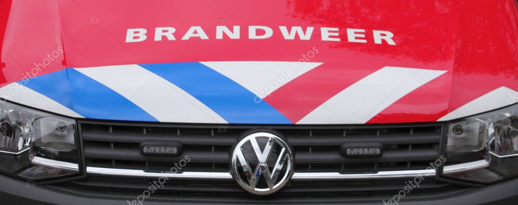 Police officer is on the back of police car measuring speed via laser gun on road named moordrechtboog N457 in Moordrecht in the Netherlands