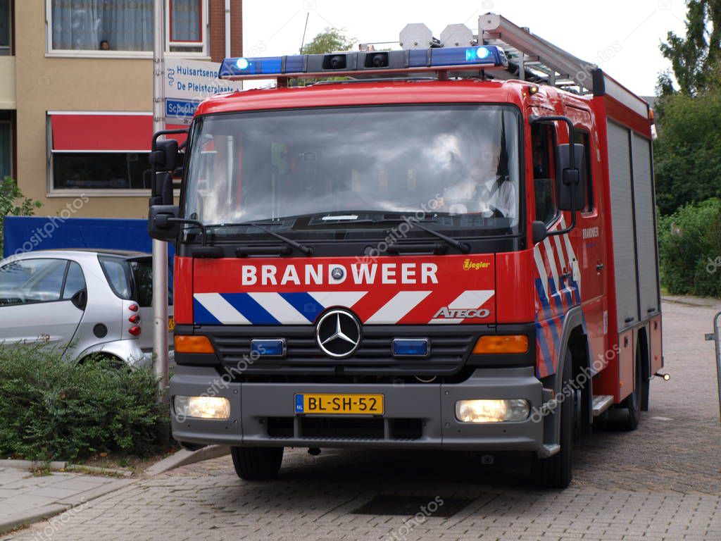 Police officer is on the back of police car measuring speed via laser gun on road named moordrechtboog N457 in Moordrecht in the Netherlands