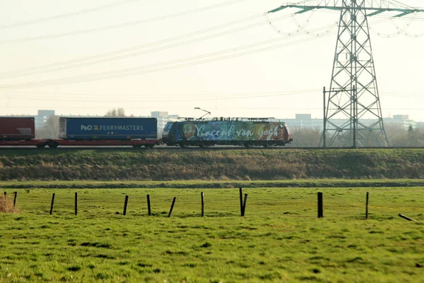 ERS locomotive for container transport painted in Vincent van Gogh theme on railroad track at Nieuwerkerk aan den IJssel in the Netherlands