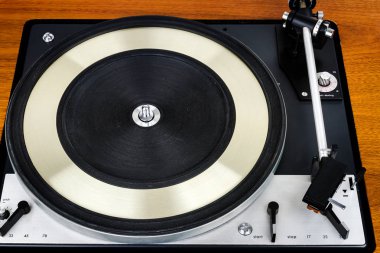 Close up of vintage turntable vinyl record player. Wooden plinth. Retro audio equipment. clipart
