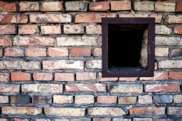 Old brick wall with a small window — Stock Photo, Image