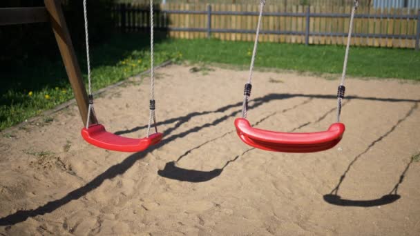 Childrens Swings Moving Back Forth Childrens Playgroundslow Motion Video Two — Stock Video