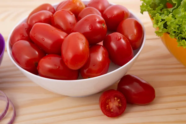 Cherry tomatoes wet.Cherry tomatoes in ceramic bowl on wooden background