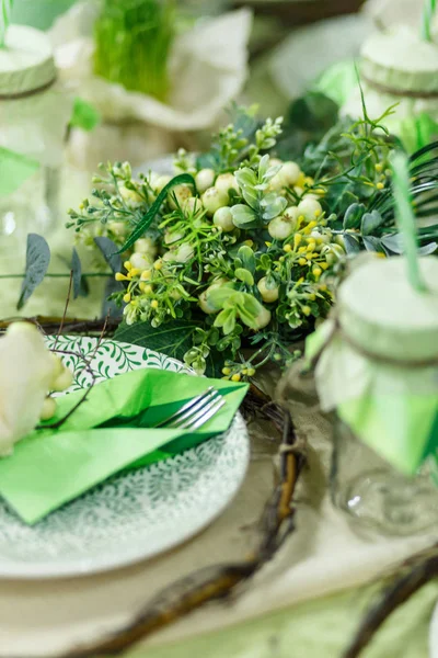 Served table at restaurant. Preparation for banquet. Restaurant table decoration for festive event. Green color