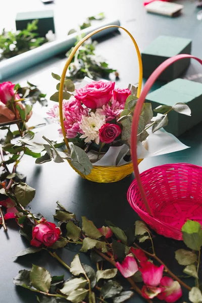 Master class of female florist at work with bunch of flowers. Girl making bouquet of various autumn flowers. Business woman florist at flower shop