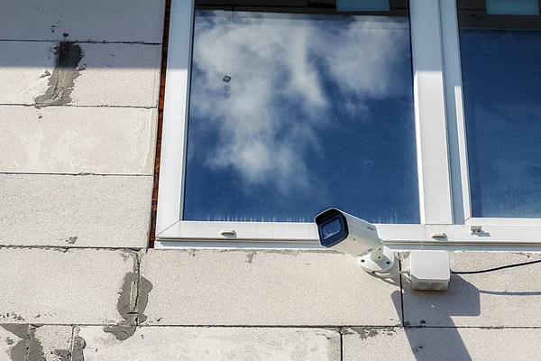 Bewakingscamera aan de muur aan huis hangen. — Stockfoto