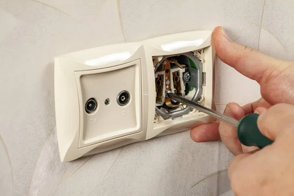 Repair an electrical outlet in the wall of a house. — Stock Photo, Image