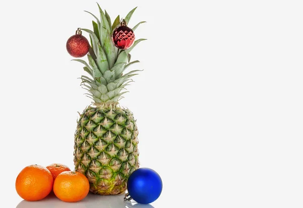 Pineapple, tangerines, Christmas toy on a white background — Stock Photo, Image