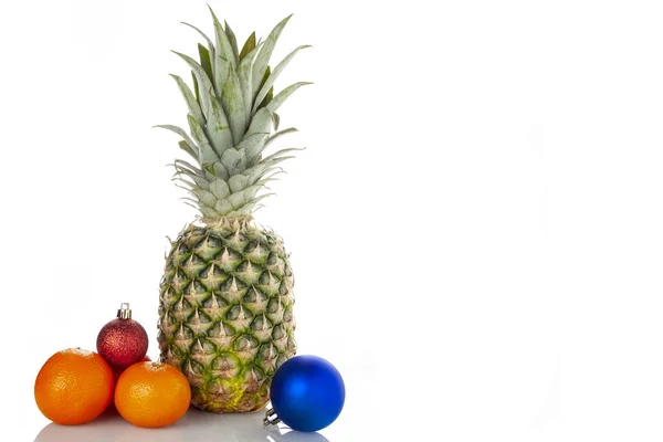 Pineapple, orange, Christmas balls, on a white background. — Stock Photo, Image