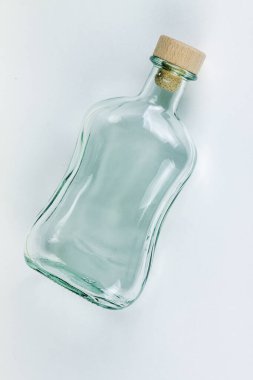 Arka planda tıpası açık olan boş şişe.