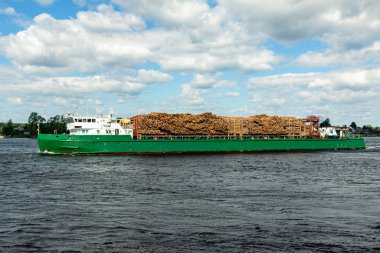 The ship is carrying logs along the river clipart